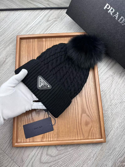 Cable-knit beanie with embroidered logo, featuring a mohair-like texture—a warm winter hat.