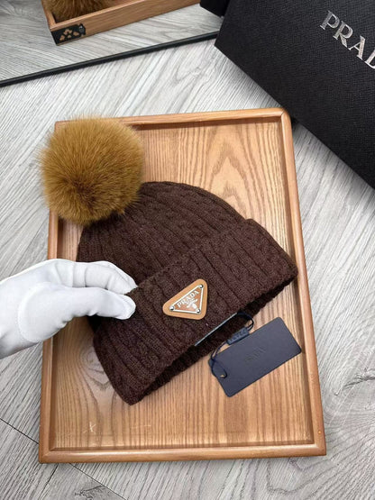 Cable-knit beanie with embroidered logo, featuring a mohair-like texture—a warm winter hat.