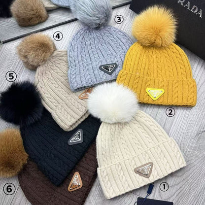 Cable-knit beanie with embroidered logo, featuring a mohair-like texture—a warm winter hat.