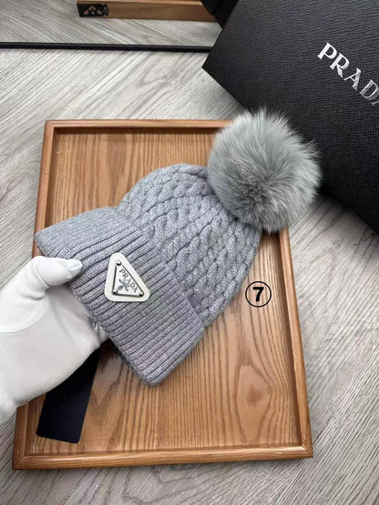 Cable-knit beanie with embroidered logo, featuring a mohair-like texture—a warm winter hat.