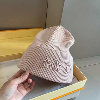 Rib-knit beanie featuring four different embroidered designs; a warm, cuffed winter hat.