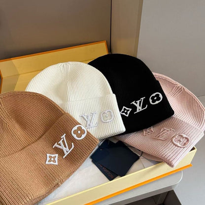 Rib-knit beanie featuring four different embroidered designs; a warm, cuffed winter hat.