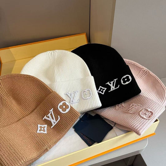 Rib-knit beanie featuring four different embroidered designs; a warm, cuffed winter hat.