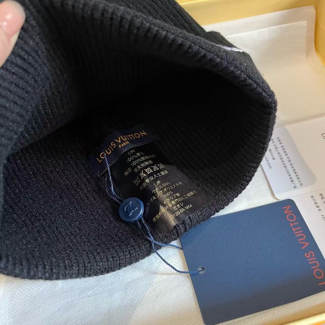 Rib-knit beanie featuring four different embroidered designs; a warm, cuffed winter hat.